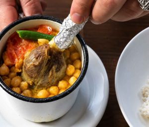 Homemade Piti stew with tender lamb, potatoes, and rich broth in a clay pot