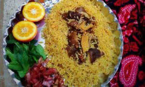 Pache polo with orange and fresh vegetables