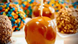 Caramel apple with colored chocolates