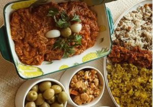 Mirza Ghasemi with rice, pickles, and olives
