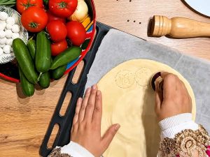 Homemade Qurutob with crispy flatbread and beef
