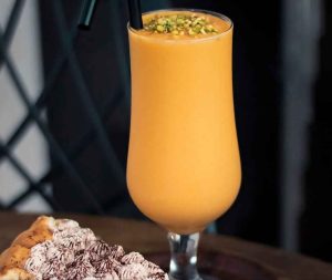Homemade mango milk recipe in a glass cup