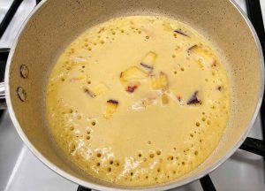 Fluffy Peach Pancakes cooking on a non-stick skillet