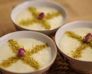 Traditional Persian rice pudding with a smooth, creamy texture and a sprinkle of cinnamon.