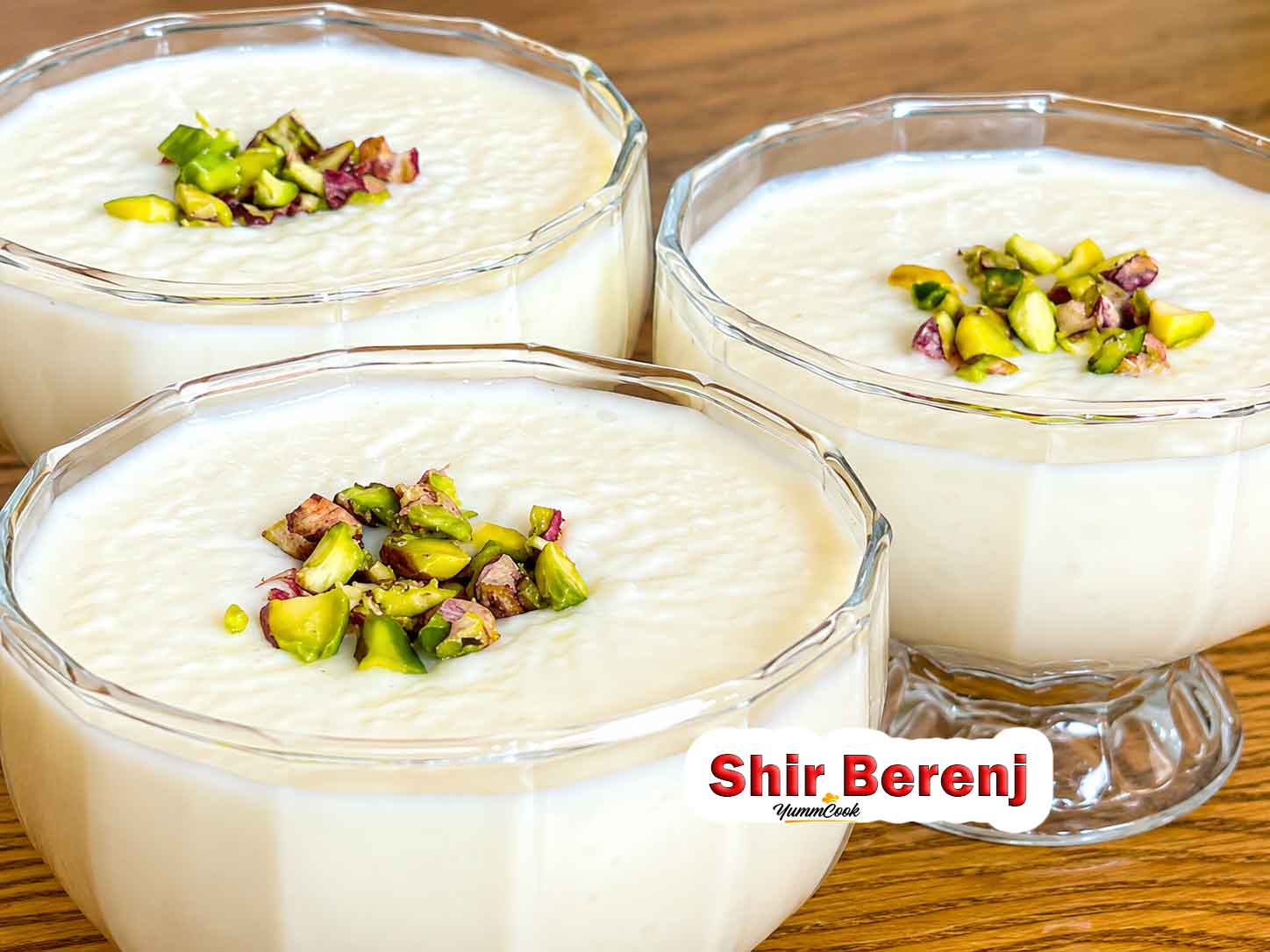 Creamy Shir Berenj (Persian rice pudding) topped with chopped pistachios and cinnamon.