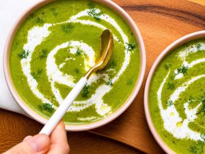 Blending homemade celery soup until smooth and creamy