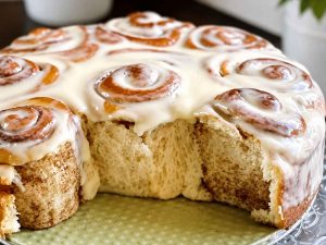 Freshly rolled cinnamon roll dough cut into individual rolls