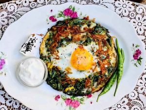 Persian Nargesi spinach and eggs served with warm bread