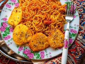 Crispy potato tahdig with golden sliced potatoes and Persian rice