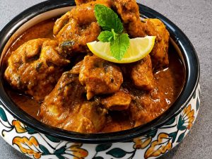 Homemade chicken korma with aromatic spices, yogurt, and cashews