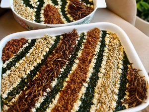 Persian eggplant dip garnished with walnuts, mint, and fried onions