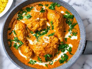 Indian butter chicken with cream and fresh cilantro