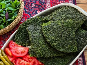 Kookoo Sabzi with tomatoes and pickles
