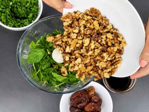 Grinding walnuts and herbs for Morgh-e Torsh