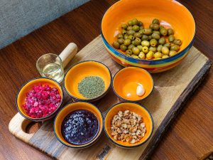 Zeytoon Parvardeh ingredients with olives, walnuts, and pomegranate molasses